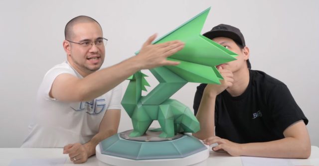 Alex Davis Pointing Out Green Paint Shades on Crystal Dragon Statue