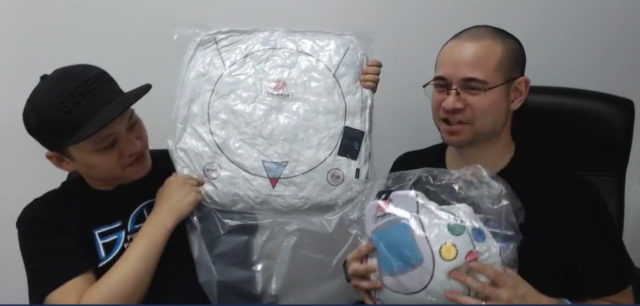 Alex and Chock Holding Dreamcast Cushions